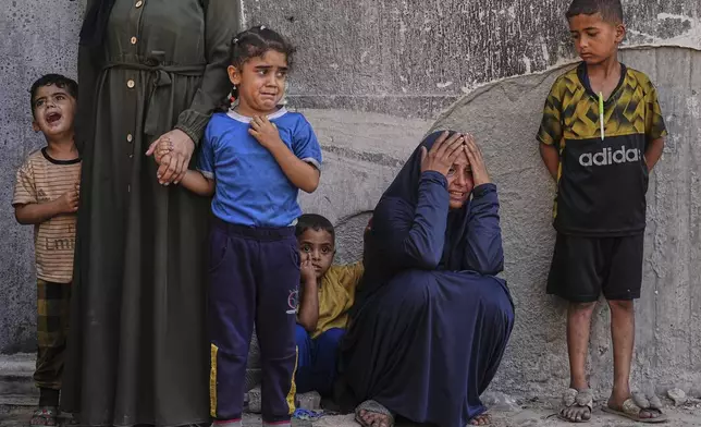 Relatives of Palestinians killed in Israeli strikes on the Gaza Strip mourn their deaths at Shifa Hospital in Gaza City, Saturday, June 28, 2025. (AP Photo/Jehad Alshrafi)
