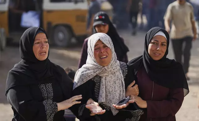 Relatives of Palestinians killed in Israeli strikes on the Gaza Strip mourn their deaths at Al-Shifa Hospital in Gaza City, Saturday, June 28, 2025. (AP Photo/Jehad Alshrafi)