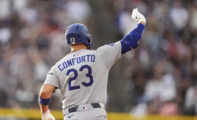 Los Angeles Dodgers' Michael Conforto gestures to the bullpen as he circles the bases after hitting a three-run home run off Colorado Rockies starting pitcher Germán Márquez in the fourth inning of a baseball game Tuesday, June 24, 2025, in Denver. (AP Photo/David Zalubowski)