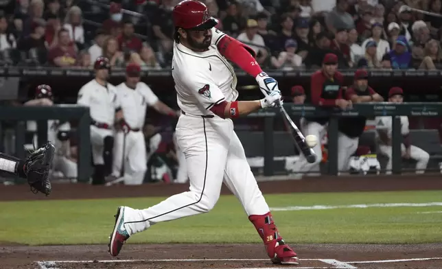 Arizona Diamondbacks' Eugenio Suárez hits a two-run home run against the Washington Nationals in the first inning during a baseball game, Sunday, June 1, 2025, in Phoenix. (AP Photo/Rick Scuteri)