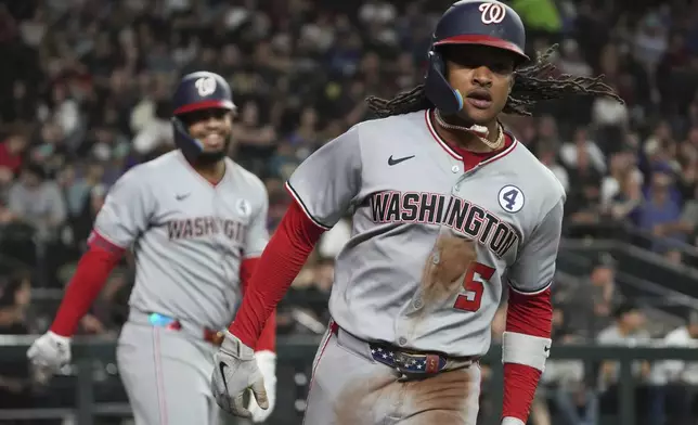Washington Nationals' CJ Abrams (5) scores a run against the Arizona Diamondbacks on a ball hit by Nathaniel Lowe in the fifth inning during a baseball game, Sunday, June 1, 2025, in Phoenix. (AP Photo/Rick Scuteri)