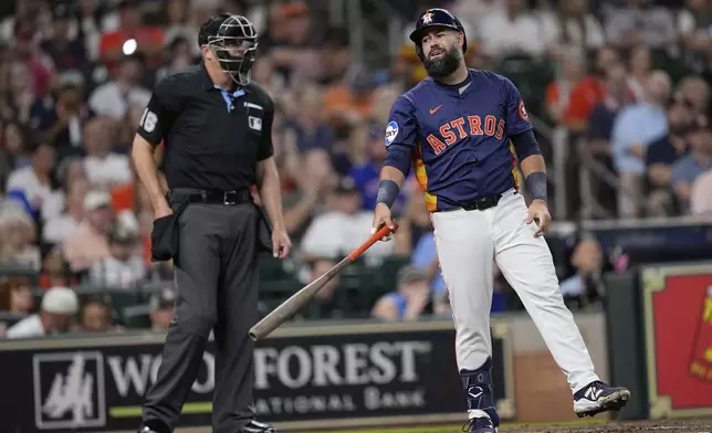 Houston Astros' Luis Guillorme, right, reacts after a strike-three call by home plate umpire Lance Barrett during the second inning of a baseball game against the Chicago Cubs Sunday, June 29, 2025, in Houston. (AP Photo/David J. Phillip)