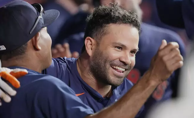 Houston Astros' Jose Altuve celebrates in the dugout after hitting a two-run home run against the Chicago Cubs during the fifth inning of a baseball game Sunday, June 29, 2025, in Houston. (AP Photo/David J. Phillip)