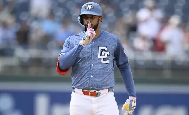 Washington Nationals' Luis Garcia Jr. gestures at second base after hitting a double during the ninth inning of a baseball game against the Miami Marlins, Saturday, June 14, 2025, in Washington. (AP Photo/Nick Wass)