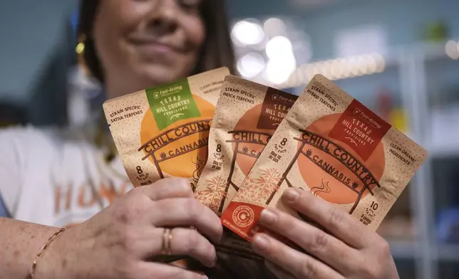 Employee Savannah Gavlik displays THC products at the Dope Daughters dispensary that Texas lawmakers are seeking to ban, Thursday, May 29, 2025, in Austin, Texas. (AP Photo/Eric Gay)