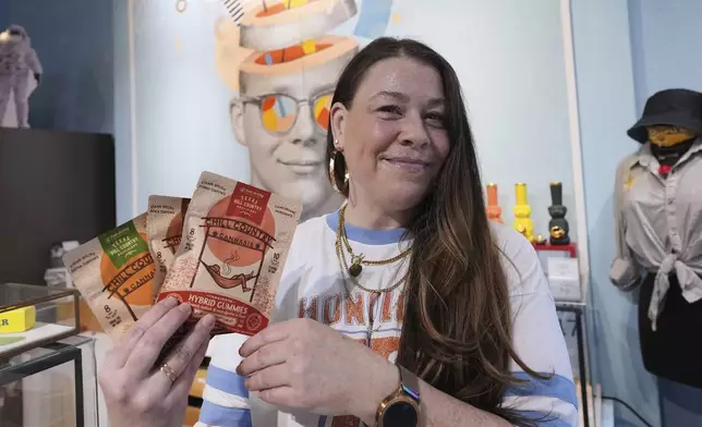 Employee Savannah Gavlik displays THC products at the Dope Daughters dispensary that Texas lawmakers are seeking to ban, Thursday, May 29, 2025, in Austin, Texas. (AP Photo/Eric Gay)