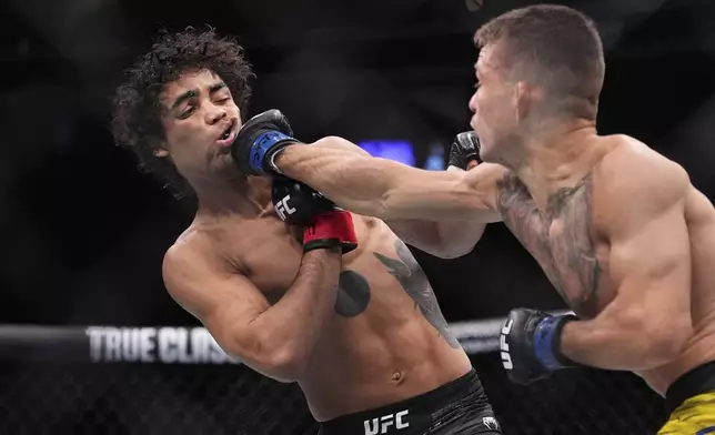 Felipe Lima hits Payton Talbott in a bantamweight fight at UFC 317, Saturday, June 28, 2025, in Las Vegas. (AP Photo/John Locher)