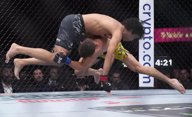 Payton Talbott, left, fights Felipe Lima in a bantamweight fight at UFC 317, Saturday, June 28, 2025, in Las Vegas. (AP Photo/John Locher)