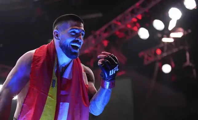 Ilia Topuria celebrates after defeating Charles Oliveira in a lightweight title fight at UFC 317, Saturday, June 28, 2025, in Las Vegas. (AP Photo/John Locher)