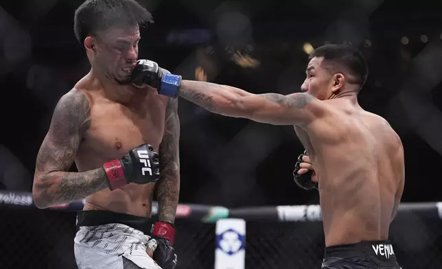 Joshua Van hits Brandon Royval in a flyweight fight at UFC 317, Saturday, June 28, 2025, in Las Vegas. (AP Photo/John Locher)