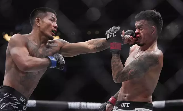 Joshua Van hits Brandon Royval in a flyweight fight at UFC 317, Saturday, June 28, 2025, in Las Vegas. (AP Photo/John Locher)