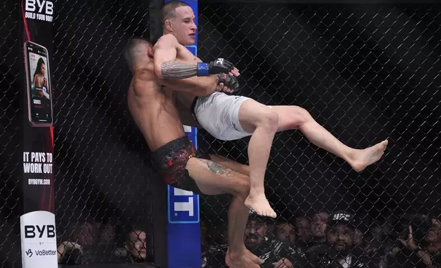 Alexandre Pantoja takes down Kai Kara-France in a flyweight title fight at UFC 317, Saturday, June 28, 2025, in Las Vegas. (AP Photo/John Locher)