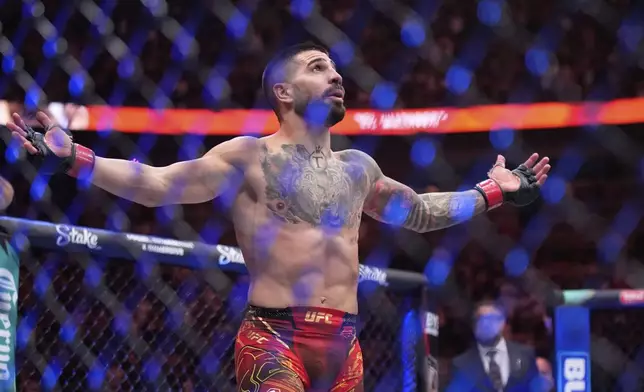 Ilia Topuria celebrates after defeating Charles Oliveira in a lightweight title fight at UFC 317, Saturday, June 28, 2025, in Las Vegas. (AP Photo/John Locher)