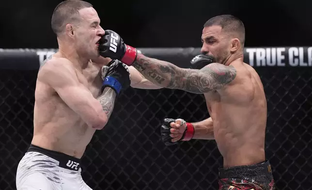 Alexandre Pantoja, right, and Kai Kara-France exchange blows in a flyweight title fight at UFC 317, Saturday, June 28, 2025, in Las Vegas. (AP Photo/John Locher)