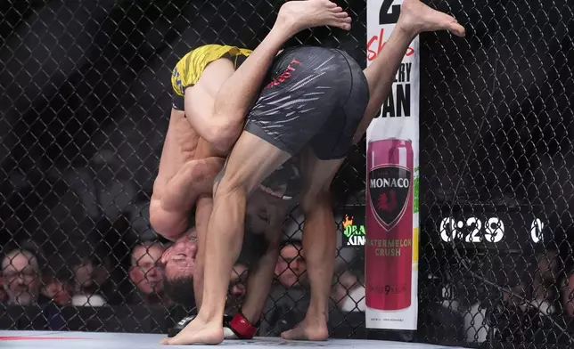 Payton Talbott, right, fights Felipe Lima in a bantamweight fight at UFC 317, Saturday, June 28, 2025, in Las Vegas. (AP Photo/John Locher)