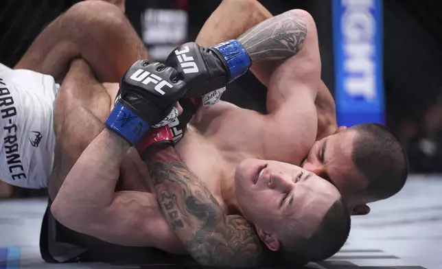 Alexandre Pantoja, right, fights Kai Kara-France in a flyweight title fight at UFC 317, Saturday, June 28, 2025, in Las Vegas. (AP Photo/John Locher)