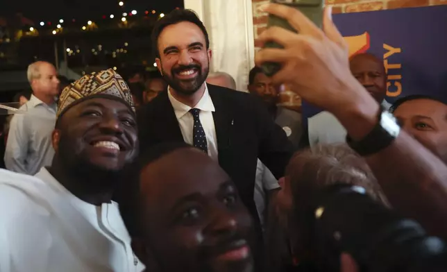 Democratic mayoral candidate Zohran Mamdani takes selfies with supporters after speaking at his primary election party, Wednesday, June 25, 2025, in New York. (AP Photo/Heather Khalifa)