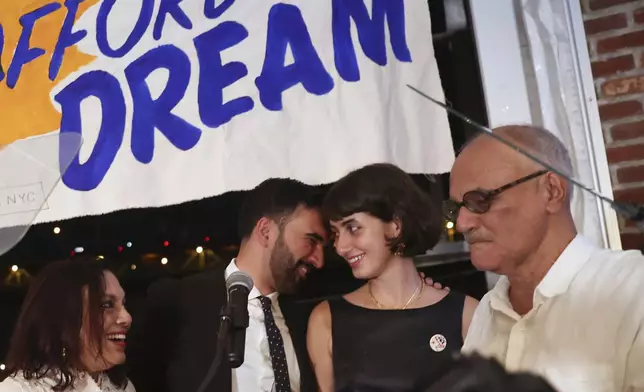 Democratic mayoral candidate Zohran Mamdani, center left, appears on stage with his wife, Rama, mother, Mira Nair Duwaji, left, and father, Mahmood Mamdani, at his primary election party, in New York, Wednesday, June 25, 2025. (AP Photo/Heather Khalifa)