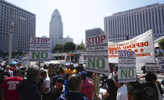 Community organizers protest outside the Federal Building after federal immigration authorities conducted an operation Friday, June 6, 2025, in Los Angeles. (AP Photo/Damian Dovarganes)