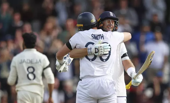 England's Joe Root, right, and batting partner Jamie Smith celebrate after their win on day five of the first cricket test match against India at Headingley in Leeds, England, Tuesday, June 24, 2025. (AP Photo/Scott Heppell)