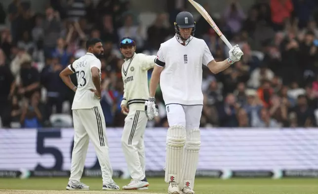 England's Zak Crawley, right, celebrates after scoring fifty runs on day five of the first cricket test match between England and India at Headingley in Leeds, England, Tuesday, June 24, 2025. (AP Photo/Scott Heppell)