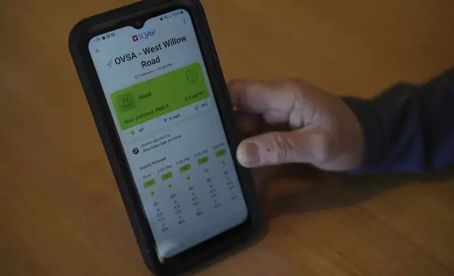 Mary Hess displays air quality data on the IQAir app on her phone Tuesday, April 8, 2025, in Dale, Ind. (AP Photo/Joshua A. Bickel)