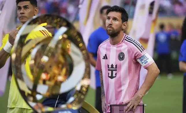 Inter Miami's Lionel Messi, right, and goalkeeper Oscar Ustari stand next to the trophy prior to the Club World Cup group A soccer match between Al Ahly and Inter Miami in Miami, Fla., Saturday, June 14, 2025. (AP Photo/Rebecca Blackwell)