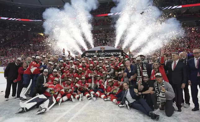 The Florida Panthers team poses with the Stanley Cup trophy after defeating the Edmonton Oilers in Game 6 of the NHL hockey Stanley Cup Final Tuesday, June 17, 2025, in Sunrise, Fla. (AP Photo/Lynne Sladky)
