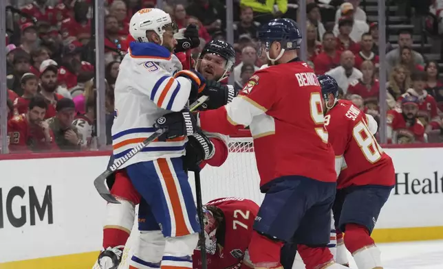 Edmonton Oilers and Florida Panthers players trade punches during the first period of Game 6 of the NHL hockey Stanley Cup Final Tuesday, June 17, 2025, in Sunrise, Fla. (AP Photo/Lynne Sladky)
