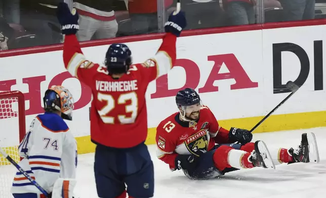 Florida Panthers' Sam Reinhart (13) celebrates his goal against Edmonton Oilers goalie Stuart Skinner (74) as Panthers' Carter Verhaeghe (23) reacts during the first period in Game 6 of the NHL hockey Stanley Cup Final in Sunrise, Fla., Tuesday, June 17, 2025. (Nathan Denette/The Canadian Press via AP)