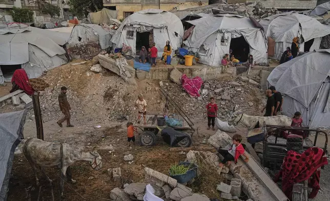 Displaced Palestinians live in a tent camp in Gaza City, Monday, June 23, 2025. (AP Photo/Jehad Alshrafi)