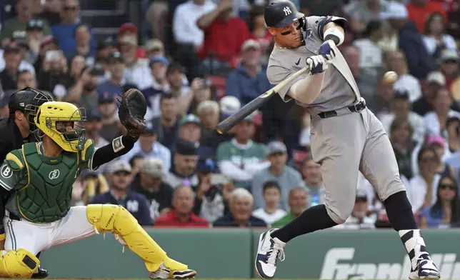 New York Yankees' Aaron Judge takes a swinging strike during the first inning of a baseball game against the Boston Red Sox, Friday, June 13, 2025, in Boston. (AP Photo/Jim Davis)