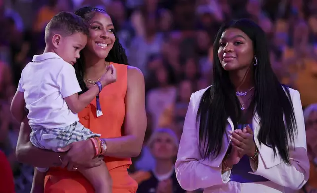 Former Los Angeles Sparks player Candace Parker, second from left, reacts with her family during her jersey retirement ceremony during a WNBA basketball game between the Sparks and the Chicago Sky, Sunday, June 29, 2025, in Los Angeles. (AP Photo/Jessie Alcheh)