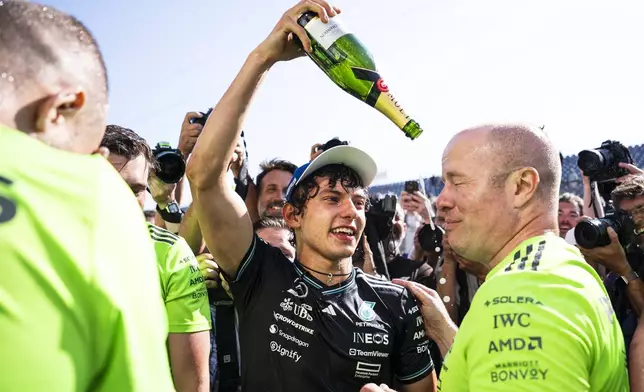 Mercedes driver Kimi Antonelli, center, of Italy, celebrates with teammates after the F1 Canadian Grand Prix auto race in Montreal, Sunday, June 15, 2025. (Christopher Katsarov/The Canadian Press via AP)