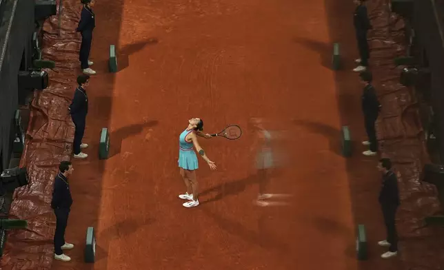 Referees are reflected in a glass as Aryna Sabalenka of Belarus reacts during the semifinal match of the French Tennis Open against Poland's Iga Swiatek at the Roland-Garros stadium in Paris, Thursday, June 5, 2025. (AP Photo/Aurelien Morissard)