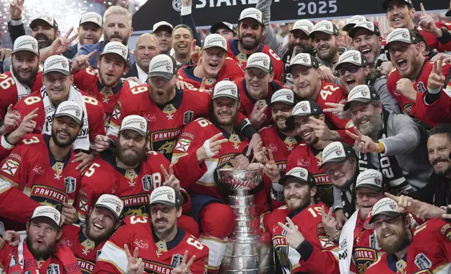 The Florida Panthers team poses with the Stanley Cup trophy after defeating the Edmonton Oilers in Game 6 of the NHL hockey Stanley Cup Final Tuesday, June 17, 2025, in Sunrise, Fla. (AP Photo/Lynne Sladky)