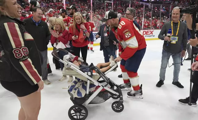 Florida Panthers defenseman Nate Schmidt (88) celebrates with his family after wining the Stanley Cup in Game 6 of the NHL hockey Stanley Cup Final against the Edmonton Oilers Tuesday, June 17, 2025, in Sunrise, Fla. (AP Photo/Lynne Sladky)