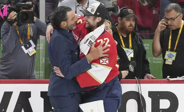 Florida Panthers goaltender Sergei Bobrovsky (72) hugs former player Roberto Luongo after defeating the Edmonton Oilers in Game 6 of the NHL hockey Stanley Cup Final Tuesday, June 17, 2025, in Sunrise, Fla. (AP Photo/Lynne Sladky)