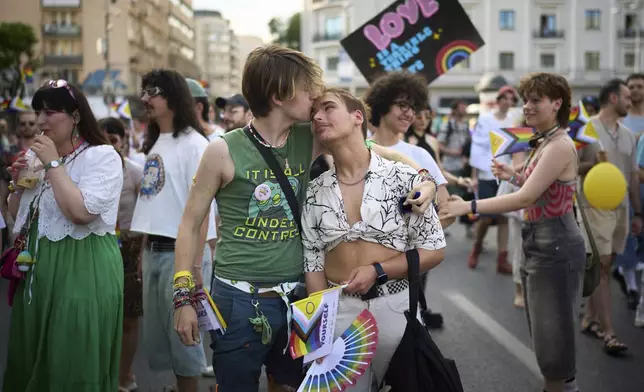 Participants in the Bucharest Pride Parade kiss in Bucharest, Romania, Saturday, June 7, 2025. (AP Photo/Vadim Ghirda)
