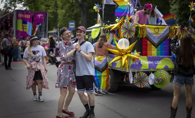 Revelers take part in the Pride March in Vilnius, Lithuania, Saturday, June 7, 2025. (AP Photo/Mindaugas Kulbis)