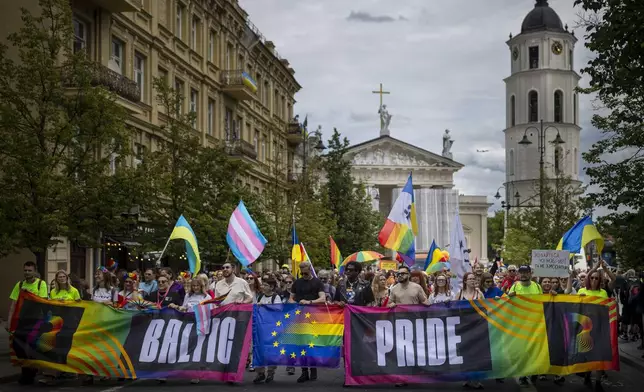 Revelers take part in the Pride March in Vilnius, Lithuania, Saturday, June 7, 2025. (AP Photo/Mindaugas Kulbis)