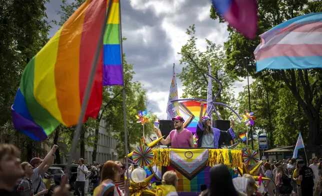 Revelers take part in the Pride March in Vilnius, Lithuania, Saturday, June 7, 2025. (AP Photo/Mindaugas Kulbis)