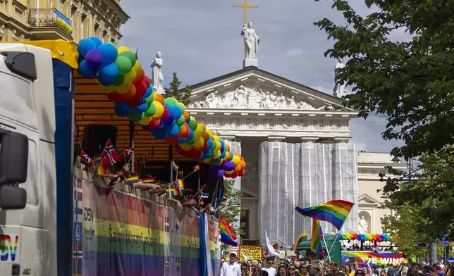 Revelers take part in the Pride March in Vilnius, Lithuania, Saturday, June 7, 2025. (AP Photo/Mindaugas Kulbis)