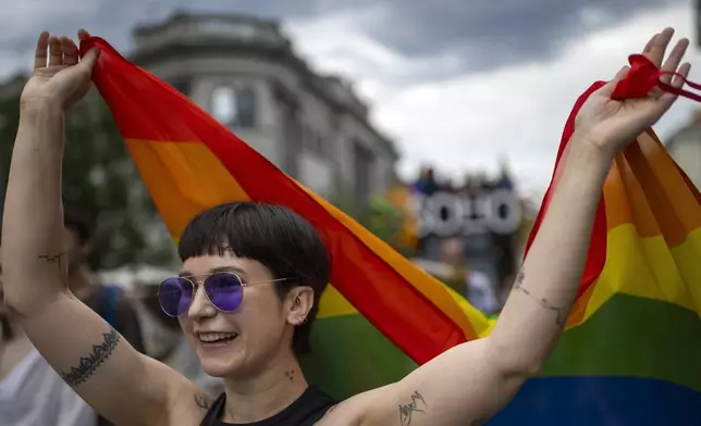 A reveler takes part in the Pride March in Vilnius, Lithuania, Saturday, June 7, 2025. (AP Photo/Mindaugas Kulbis)