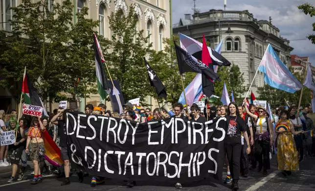 Revelers take part in the Pride March in Vilnius, Lithuania, Saturday, June 7, 2025. (AP Photo/Mindaugas Kulbis)