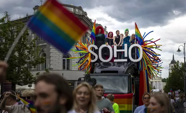Revelers take part in the Pride March in Vilnius, Lithuania, Saturday, June 7, 2025. (AP Photo/Mindaugas Kulbis)