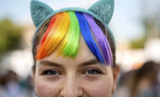 A woman poses for a portrait during the Bucharest Pride Parade in Bucharest, Romania, Saturday, June 7, 2025. (AP Photo/Andreea Alexandru)