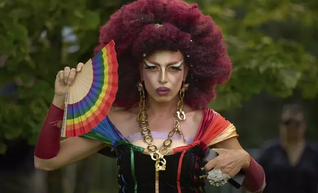 A participant in the Bucharest Pride Parade strikes a pose in Bucharest, Romania, Saturday, June 7, 2025. (AP Photo/Vadim Ghirda)