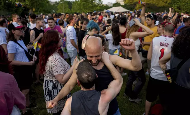 Participants in the Bucharest Pride Parade dance in Bucharest, Romania, Saturday, June 7, 2025. (AP Photo/Andreea Alexandru)
