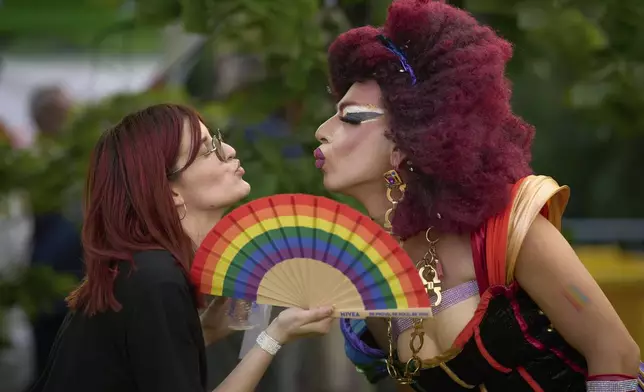 Participants in the Bucharest Pride Parade pose in Bucharest, Romania, Saturday, June 7, 2025. (AP Photo/Vadim Ghirda)
